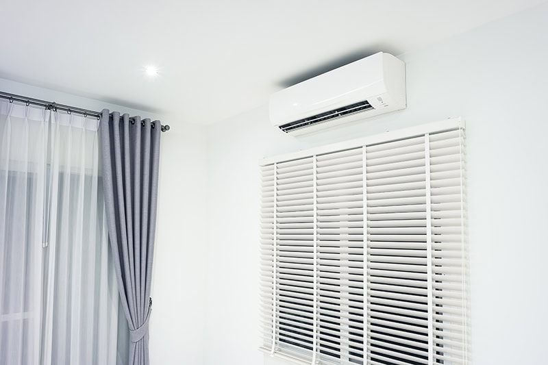 A white wall-mounted air conditioning unit.