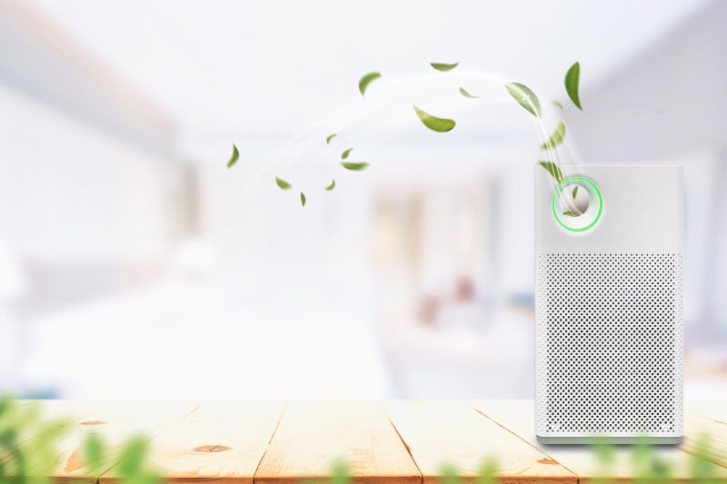 A white purifier on a wooden surface.